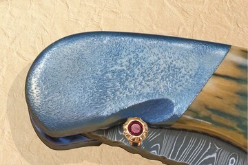 Stainless Damascus and Ruby Folder bolster view