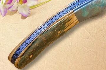 Stainless Damascus and Ruby Folder spine view