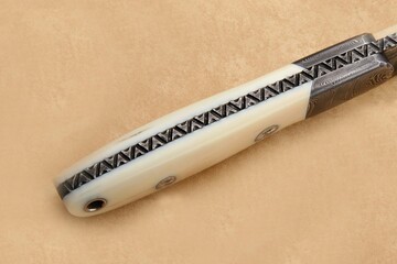 Walrus and Damascus Hunter Knife Engraved spine view