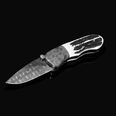 Sambar Stag and Damascus Folding Knife black white image