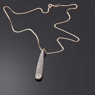 Chocolate diamond set in yellow gold and stainless damascus pendant
