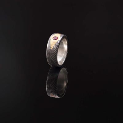 Forged Damascus ring with genuine ruby set in 24 carat yellow gold