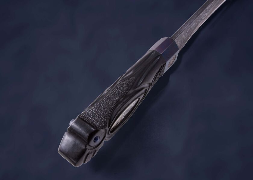 Skraeling Biter Damascus Fighter with carved raven spine view