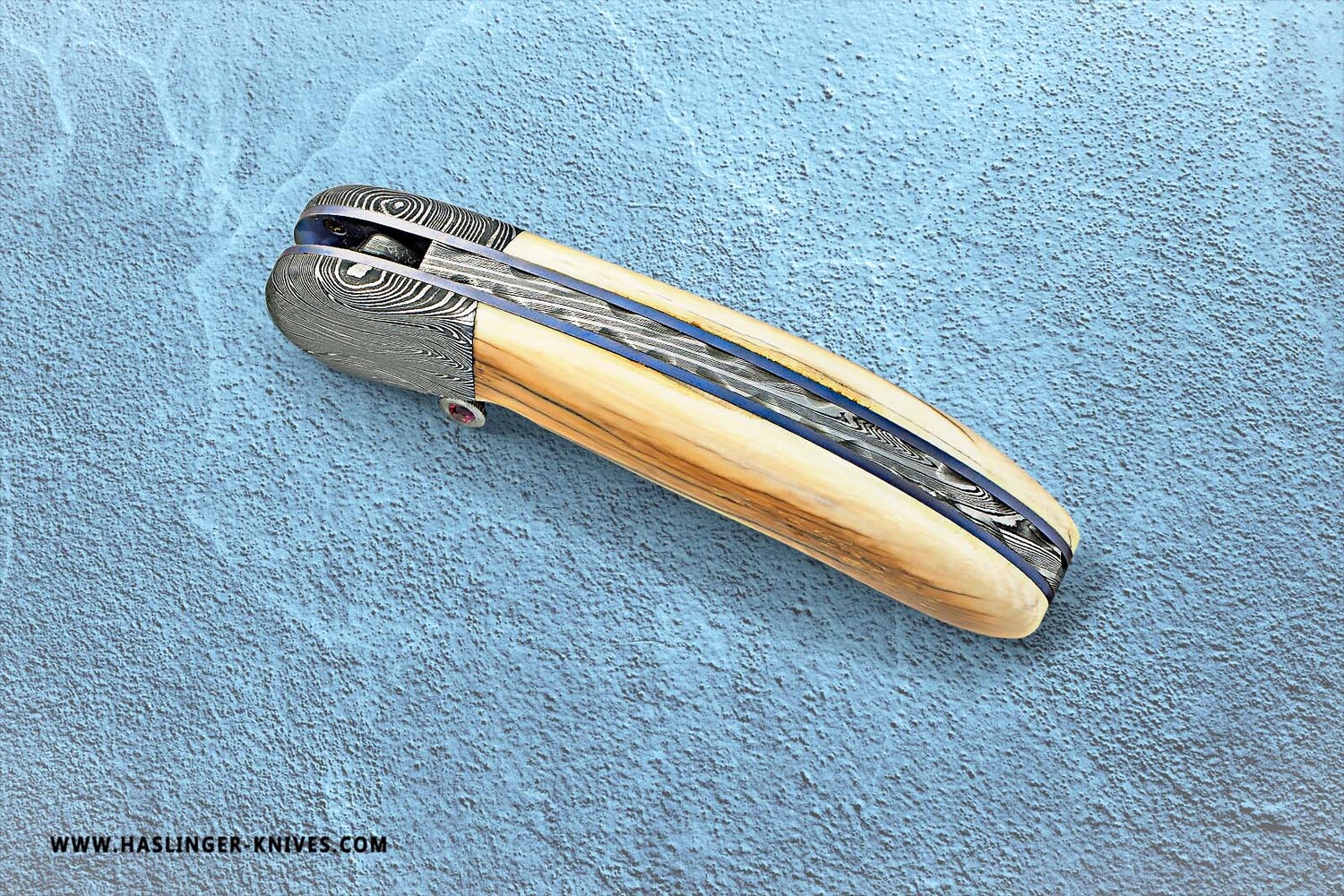 Mammoth Ivory Damascus and Ruby Folder spine view
