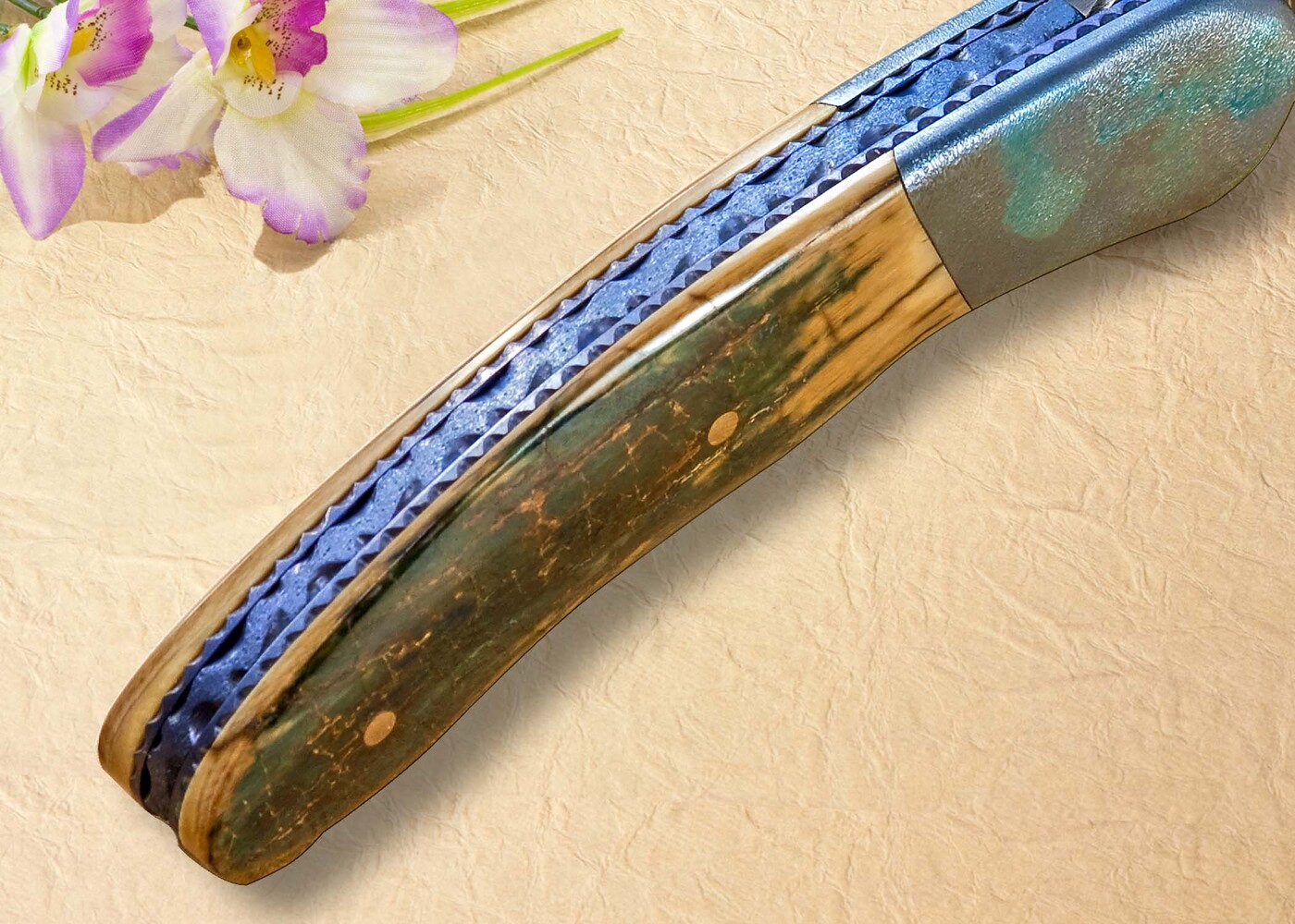Stainless Damascus and Ruby Folder spine view