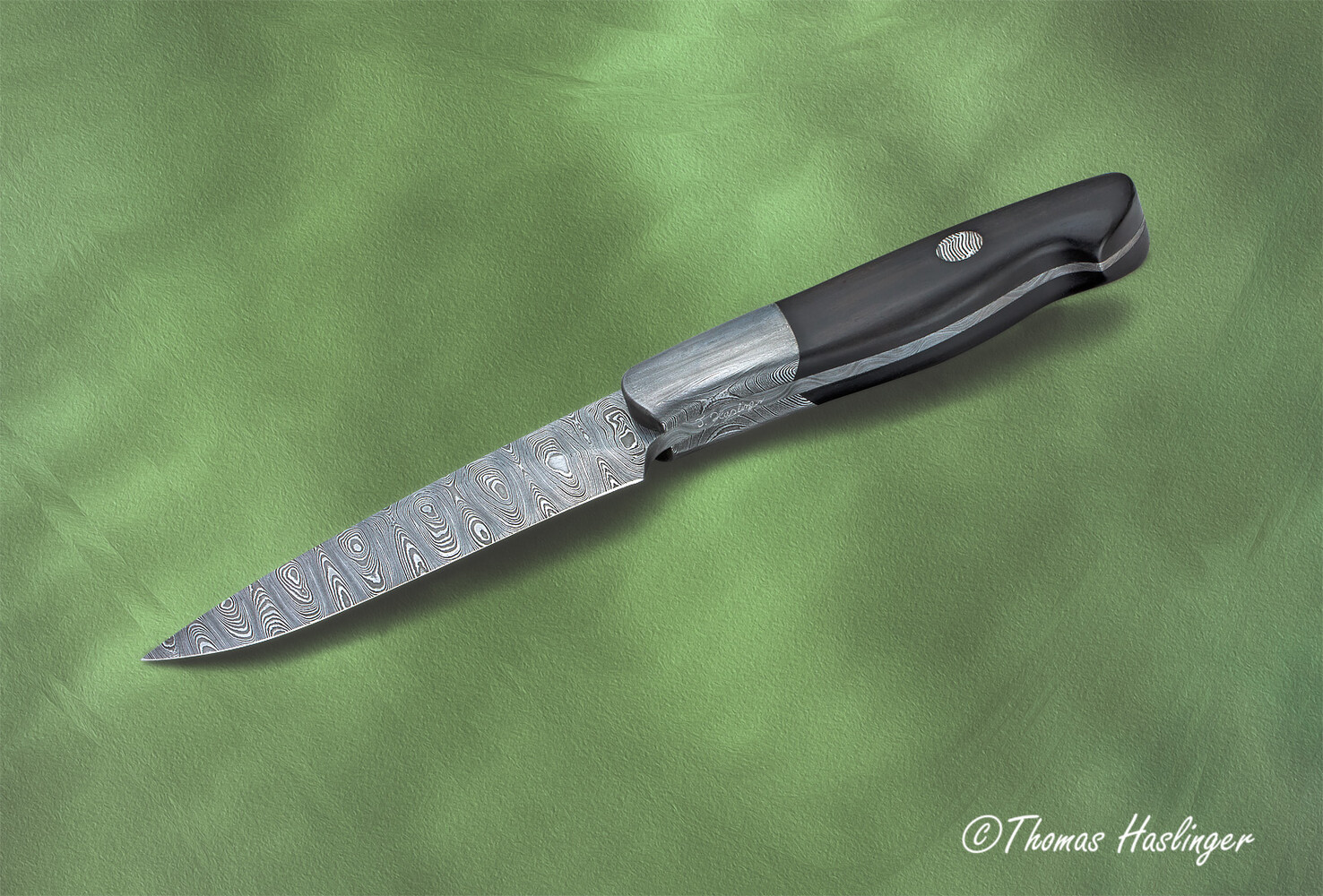 Cape Breton Hunter in Ladder Damascus and Ebony Handle edge view