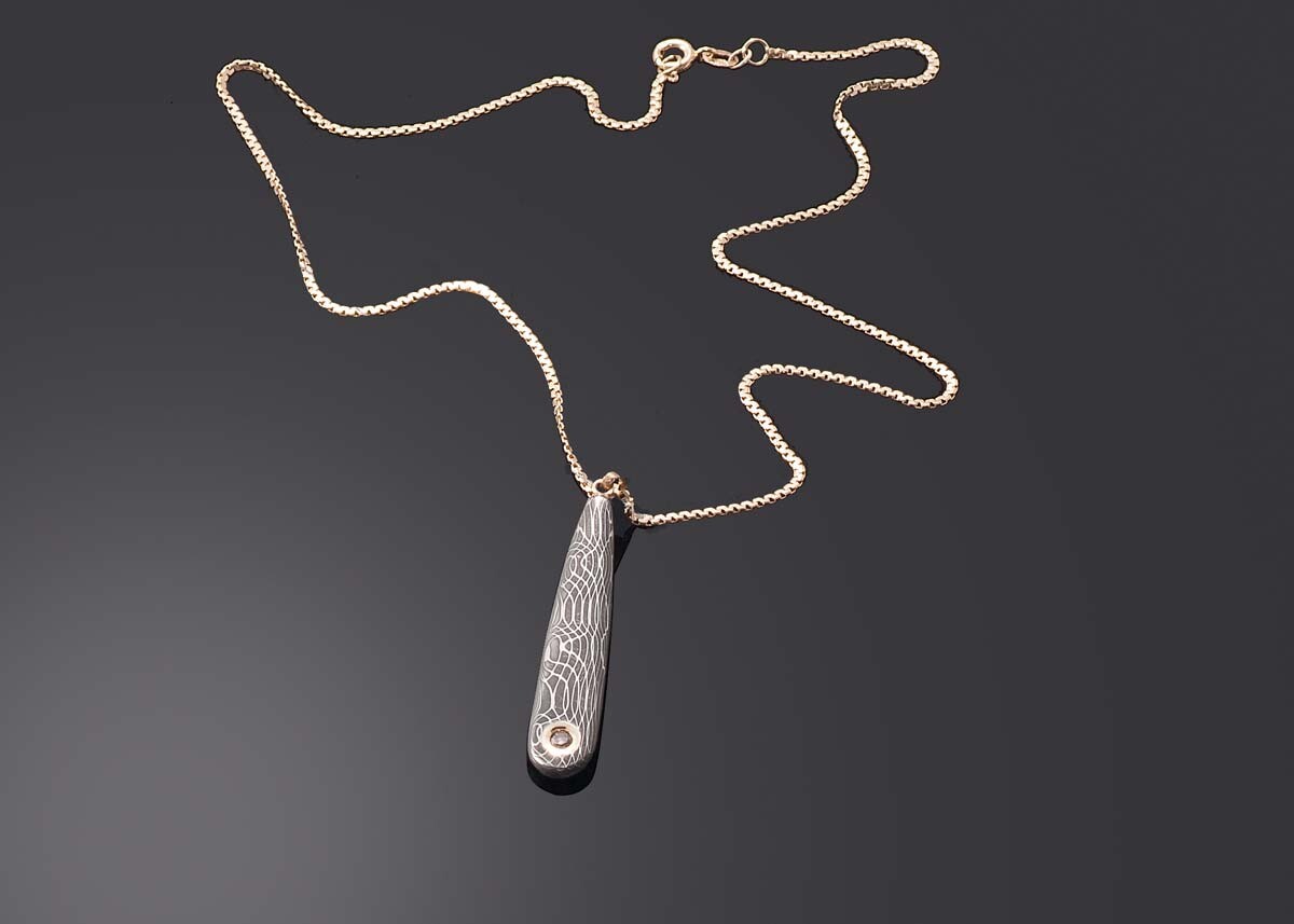Chocolate diamond set in yellow gold and stainless damascus pendant